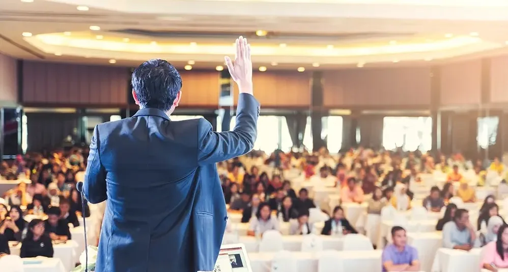 Keynote speaker addressing a packed corporate audience at Suganya Convention Centre, Pondicherry