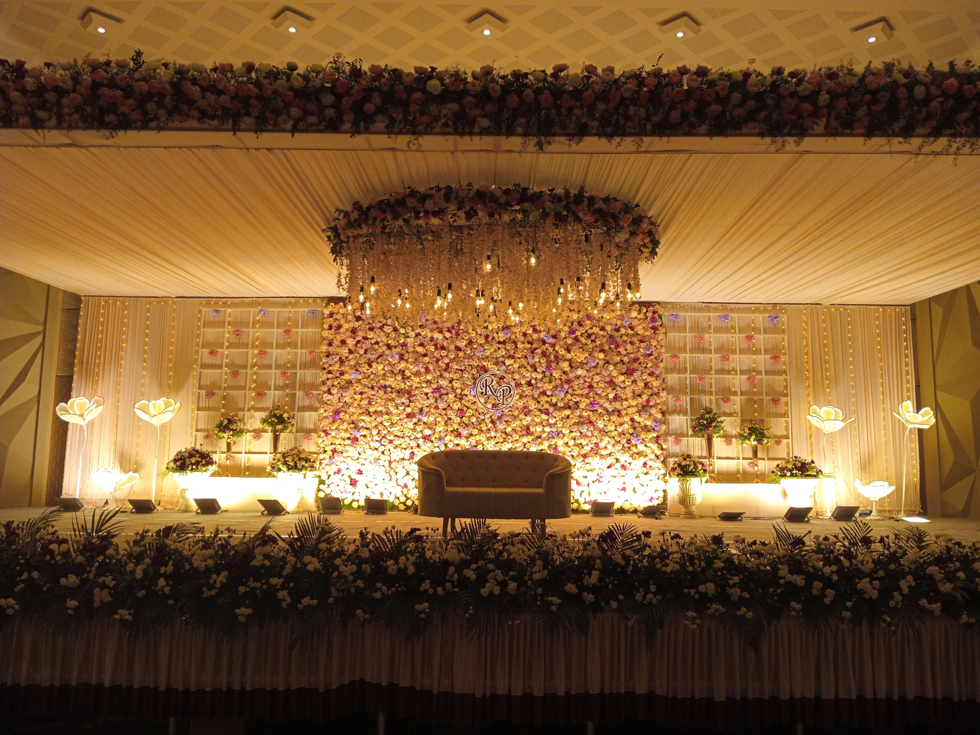 Grand floral wedding reception stage at Suganya Convention Centre, Pondicherry
